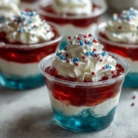 Vibrantly layered 4th of July Firecracker Jello Shots sparkle with fruity goodness.